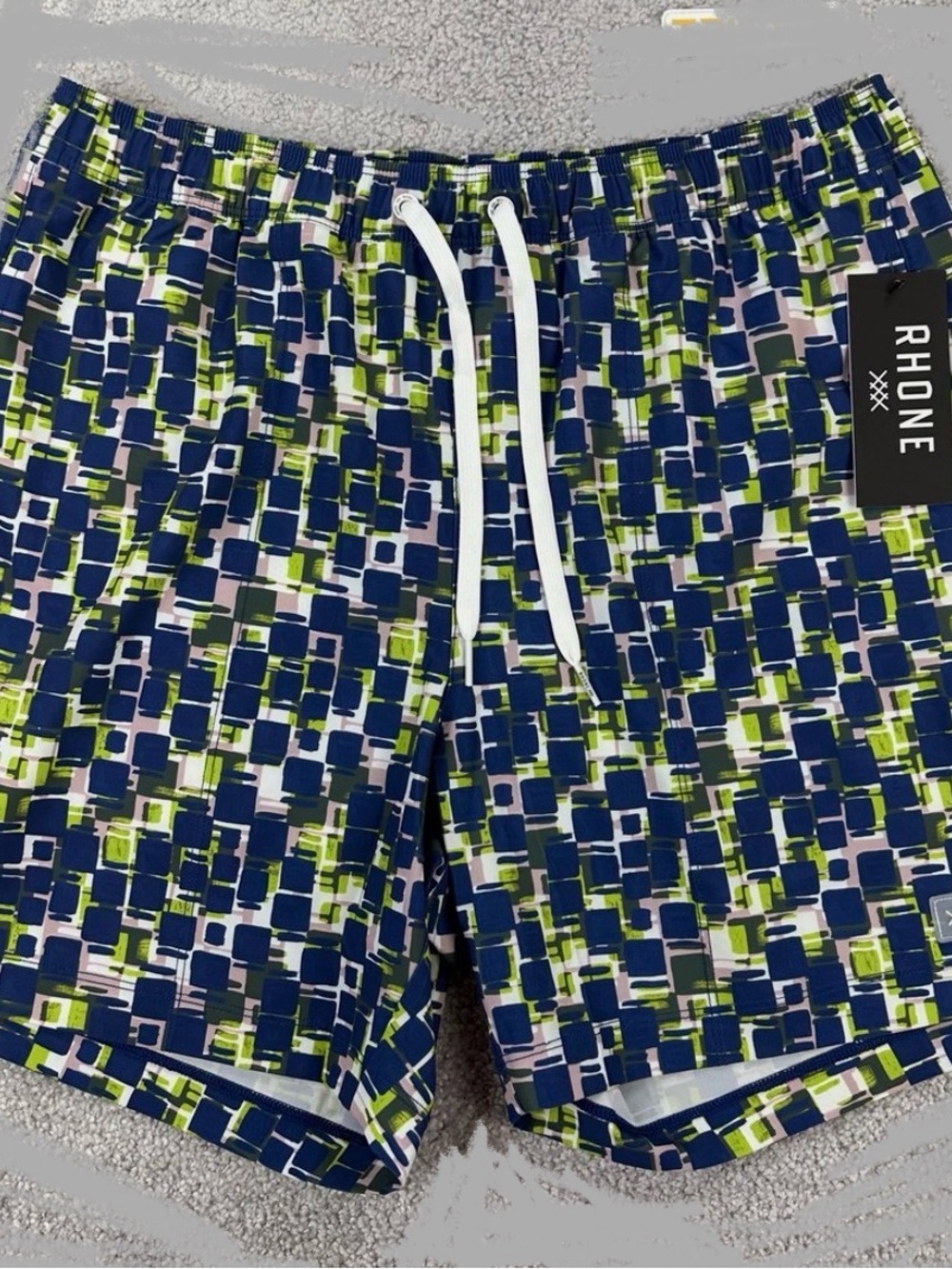 RHONE  5.5” Men’s Swim Trunks in Navy, Green & White Geo-Block
